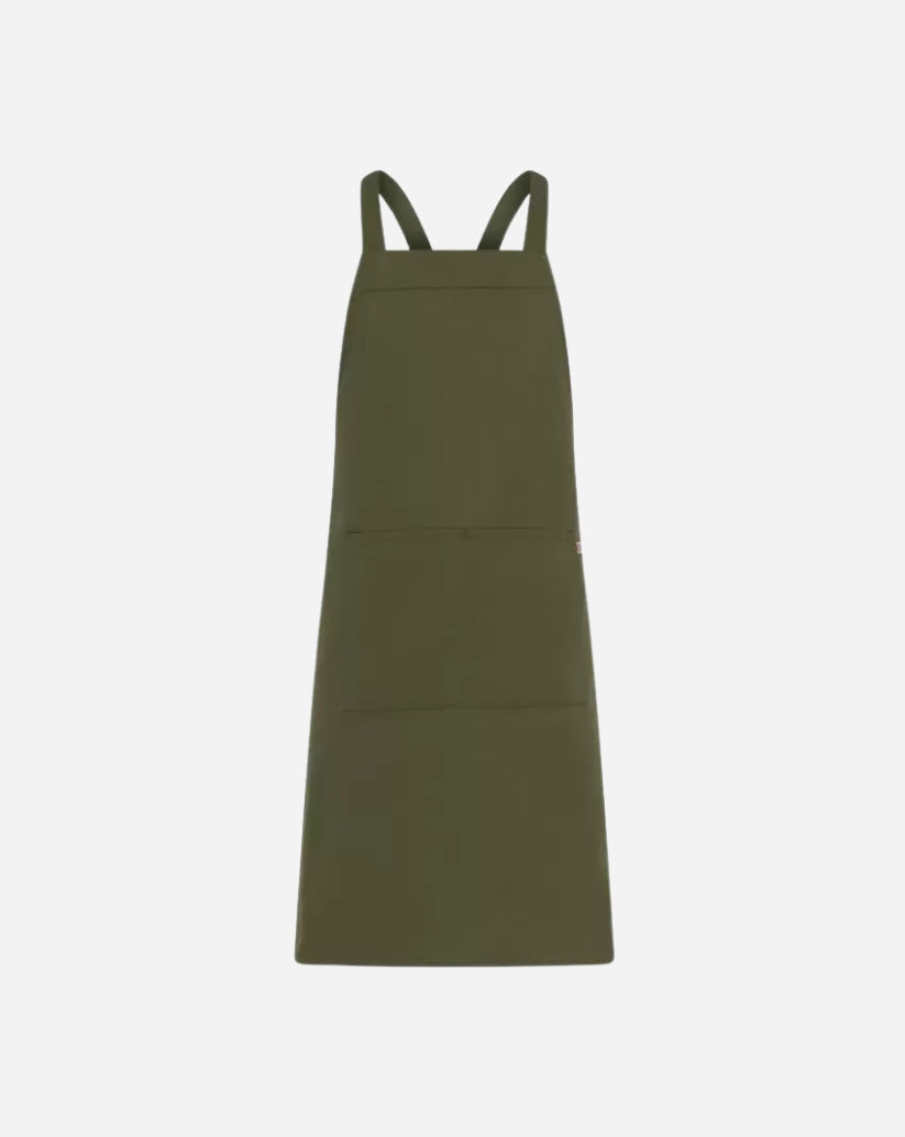 Grembiule unisex verde militare in poliestere e cotone con pettorina, tasca centrale e allacciatura con bretelle regolabili tramite anello in ottone.