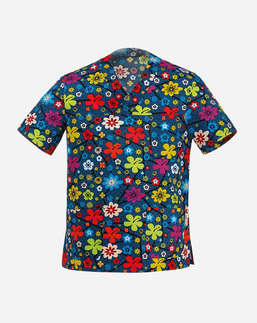 Casacca unisex con scollo a V in misto cotone blu navy, caratterizzata da una vivace fantasia floreale multicolore con fiori stilizzati nei toni del rosso, rosa, giallo e azzurro su uno sfondo a texture geometrica circolare, dotata di taschino sul petto e due ampie tasche inferiori.