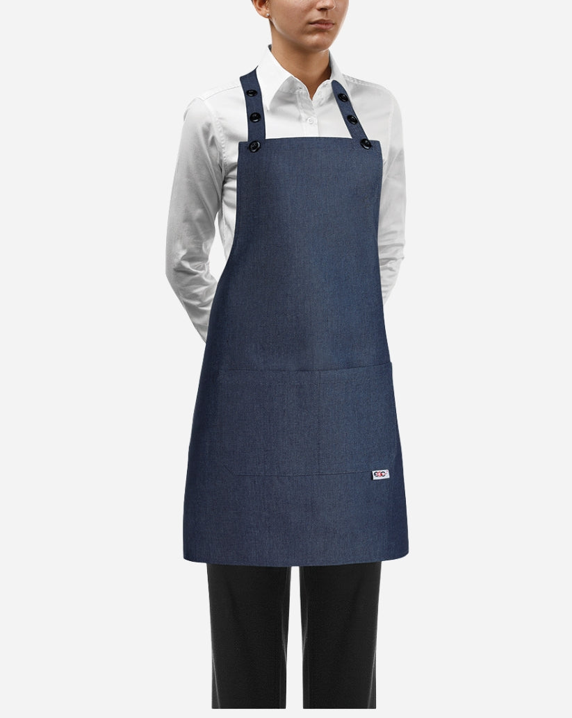 Grembiule a pettorina donna jeans in cotone e poliestere con chiusura regolabile al collo, bottoni e due tasche centrali applicate.