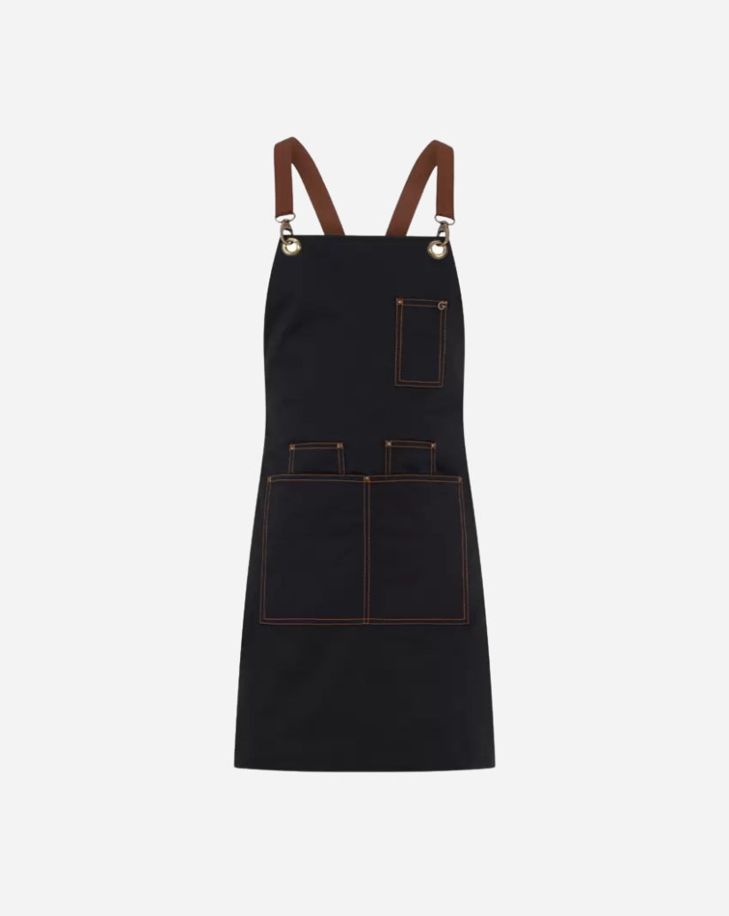 Grembiule unisex nero in poliestere e cotone con bretelle staccabili,  tre portapenne, due tasche ampie e vele in ottone.